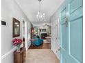 Inviting entryway with chandelier leading to the living room with fireplace and hardwood floors at 3157 Hermitage Dr., Little River, SC 29566