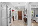 Grand entryway with tiled floors, chandelier, and views into the bedroom and dining room at 3157 Hermitage Dr., Little River, SC 29566