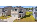 Beautifully landscaped two-story home featuring a two-car garage with a community pool nearby at 3968 Hibiscus Dr., Little River, SC 29566