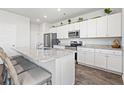 Open kitchen with stainless steel appliances, granite counters, and an island with bar seating at 3968 Hibiscus Dr., Little River, SC 29566