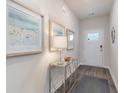 Inviting entryway featuring decorative artwork, a mirrored table, and stylish flooring for a warm welcome at 418 Glade Ct., Loris, SC 29569