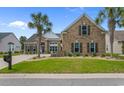 Charming brick home with a well-manicured lawn and palm trees, perfect for southern living at 4311 Grovecrest Circle, North Myrtle Beach, SC 29582