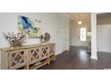 Inviting entryway with hardwood floors, decorative cotton stem and view of the front door at 435 Clear Lake Dr., Conway, SC 29526