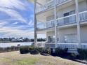 Condo back view of covered balconies overlooking a serene waterfront at 4425 Eastport Blvd. # I-1, Little River, SC 29566