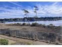 Scenic waterfront view with marshy shoreline and waterfront homes in the background at 4425 Eastport Blvd. # I-1, Little River, SC 29566
