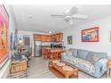 Inviting living room with a couch, dinette, TV, and open kitchen with island and barstool seating at 4516 Seaview St. # 135, North Myrtle Beach, SC 29582