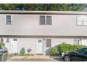 Townhouse front entrance showcasing address, white door, and simple landscaping at 4616 Lomax Ct. # 9-B, Murrells Inlet, SC 29576