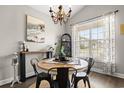 Dining room featuring a round table, modern chandelier, and bright window with sheer curtains at 4697 Farm Lake Dr., Myrtle Beach, SC 29579