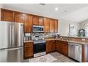 Well-equipped kitchen with stainless steel appliances, granite countertops, and wood cabinetry at 4697 Farm Lake Dr., Myrtle Beach, SC 29579