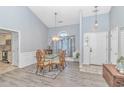 Elegant dining room featuring a glass-top table, stylish chairs, and a decorative chandelier for refined dining at 5 Old Barge Dr., Pawleys Island, SC 29585