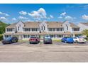 Inviting townhomes featuring neutral siding, complemented by convenient parking spaces and attractive landscaping at 500 Fairway Village Dr. # 7-C, Myrtle Beach, SC 29588