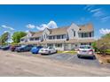 Charming townhomes feature neutral siding, complemented by convenient parking spaces and attractive landscaping at 500 Fairway Village Dr. # 7-C, Myrtle Beach, SC 29588