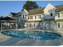 Community pool featuring a gated perimeter and a covered dining space at 500 Fairway Village Dr. # 7-C, Myrtle Beach, SC 29588