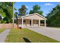 Inviting single-story home with a covered entrance, showcasing a well-maintained lawn and a fenced yard at 509 S Rosemary Ave., Andrews, SC 29510