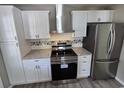 Modern kitchen featuring white cabinets, stainless steel appliances, and granite countertops at 509 S Rosemary Ave., Andrews, SC 29510