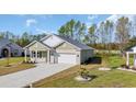 Beautiful single-story home featuring a white brick facade, attached garage, and well-maintained lawn at 534 War Eagle Ct., Conway, SC 29526