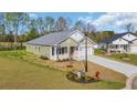 Attractive single-story home with white brick accents, attached garage, and a lush green yard at 534 War Eagle Ct., Conway, SC 29526