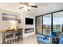 Living room featuring a modern fireplace, balcony access and ocean view at 5523 N Ocean Blvd. # 1201, Myrtle Beach, SC 29577