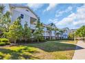 Condo exterior featuring well-maintained lawn and landscaping with palm trees and siding at 5801 Oyster Catcher Dr. # 1621, North Myrtle Beach, SC 29582