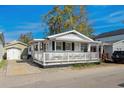 Cozy single-story home featuring a spacious porch area, well-manicured landscaping, and adjacent parking at 6001- 1776 S Kings Highway, Myrtle Beach, SC 29575