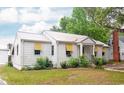 An eye-level view shows the side and front of a charming white cottage-style home at 640 Willowbank Rd., Georgetown, SC 29440