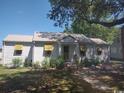 Quaint single story home with metal roof, yellow awnings, mature trees, and brick pathway at 640 Willowbank Rd., Georgetown, SC 29440