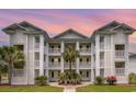 Beautiful three-story building showcasing a tropical landscape during dusk at 673 Tupelo Ln. # G, Longs, SC 29568