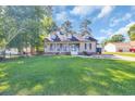 Inviting exterior featuring a well-manicured lawn and a charming front porch on a sunny day at 6864 Woodhaven Dr., Myrtle Beach, SC 29588