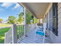 Relaxing covered front porch with comfortable rocking chairs and serene views of the neighborhood at 6864 Woodhaven Dr., Myrtle Beach, SC 29588
