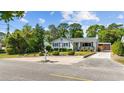 Charming one-story home with well-kept landscaping, a gravel driveway, and a serene, inviting curb appeal at 709 Yucca Ave., Myrtle Beach, SC 29577