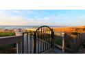 Scenic beach access point featuring a wooden walkway, gate, and views of the ocean at 7100 N Ocean Blvd. # 621, Myrtle Beach, SC 29572