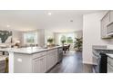 Bright kitchen featuring granite countertops, a large island, stainless steel appliances and hardwood flooring at 7399 Meadow Walk Loop, Loris, SC 29569