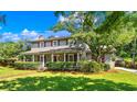 Traditional two-story home with red shutters, lush landscaping, and inviting front porch at 7602 Glenwood Dr., Myrtle Beach, SC 29572