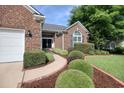 Close up of a lovely brick home featuring manicured landscaping and a cozy entrance at 78 Saltwind Loop, Murrells Inlet, SC 29576