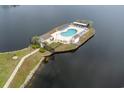Overhead view of community pool area with lounge chairs and palm trees on an island at 8887 Chandler Dr. # A, Myrtle Beach, SC 29575