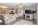 Inviting living area features a cozy fireplace, ceiling fan and open layout at 8887 Chandler Dr. # A, Myrtle Beach, SC 29575