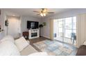 Comfortable living room includes access to a screened porch and an electric fireplace at 8887 Chandler Dr. # A, Myrtle Beach, SC 29575