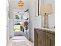 Bright foyer with wood floors, wainscoting, and a charming view of the outdoors at 1010 Graybill Lane, North Myrtle Beach, SC 29582
