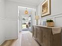 Elegant foyer featuring wainscoting, hardwood floors, and tasteful decor at 1010 Graybill Lane, North Myrtle Beach, SC 29582
