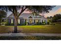 Charming one-story home with stone and siding, with warm lights at dusk at 1028 Whooping Crane Dr., Conway, SC 29526
