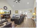 Bright and airy living room featuring hardwood floors, comfortable furniture, and a vaulted ceiling at 113 Edwards Ln., Longs, SC 29568