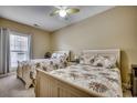 Cozy bedroom features two twin beds, ceiling fan, and window for natural light at 116 Cypress Point Ct. # 302, Myrtle Beach, SC 29579