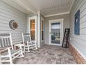 Cozy front porch featuring rocking chairs, decorative accessories, and a welcoming entrance at 1211 Arezzo Ave., Myrtle Beach, SC 29572