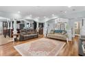 Open-concept living room with hardwood floors, recessed lighting, and seamless flow to the kitchen at 130 Pier Pointe Dr., Little River, SC 29566