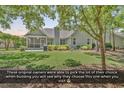 Well-maintained backyard with lush lawn, mature landscaping, and covered patio area at 156 Summerlight Dr., Murrells Inlet, SC 29576