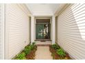 Inviting entryway featuring double doors, classic columns, and lush landscaping at 1617 Tradition Club Dr., Pawleys Island, SC 29585