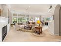 Sun-filled living room featuring a fireplace, large windows, and neutral decor at 1617 Tradition Club Dr., Pawleys Island, SC 29585