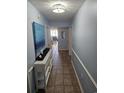 Light blue hallway with decorative table and artwork on the walls at 1625 S Ocean Blvd. # 106, North Myrtle Beach, SC 29582