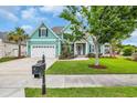Inviting curb appeal with a lush green lawn, mature landscaping, and a charming two-car garage at 2004 Crow Field Ct., Myrtle Beach, SC 29579