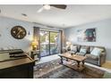 Light and bright living room featuring large sliding glass doors to the balcony at 204 Maison Dr. # N304, Myrtle Beach, SC 29572